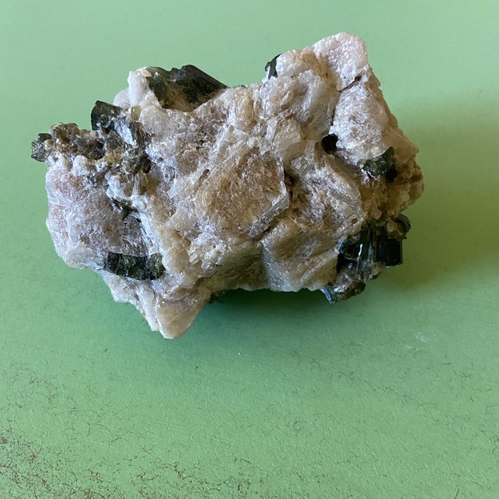 Green tourmaline crystal on feldspar